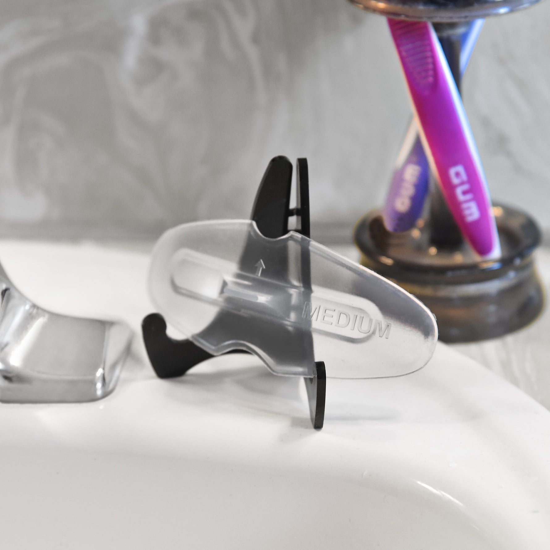 SomnoSeal on sink with toothbrushes in background.