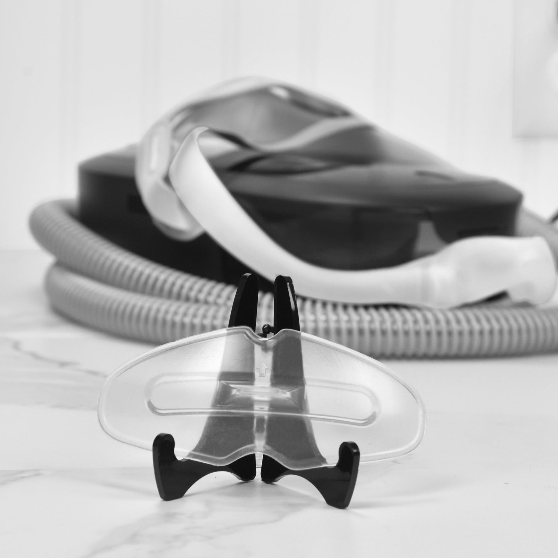 SomnoSeal in from of CPAP mask and hose on a white background
