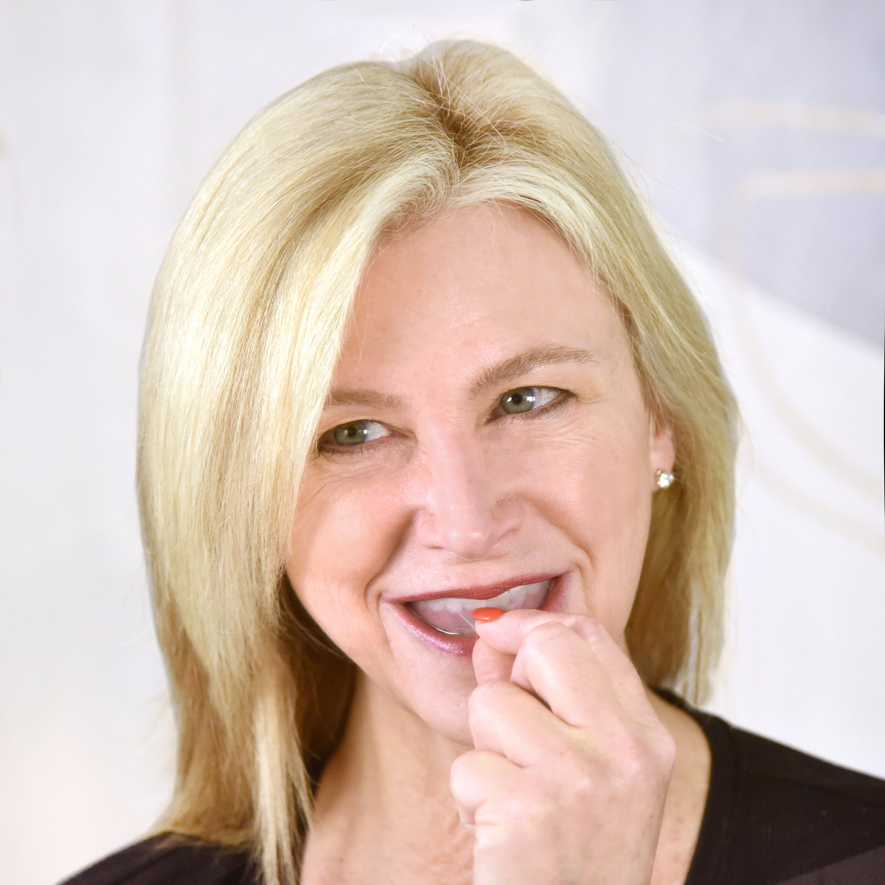 Woman putting SomnoSeal in her mouth